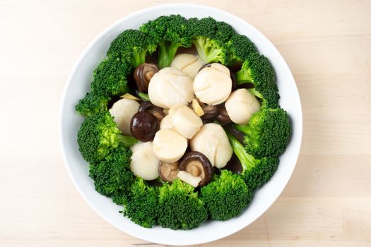 Top view stir fried fresh scallops with broccoli and mushroom, Chinese style