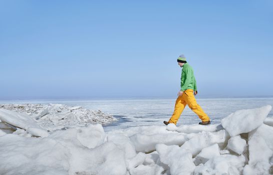 Young adult man outdoors exploring icy landscape