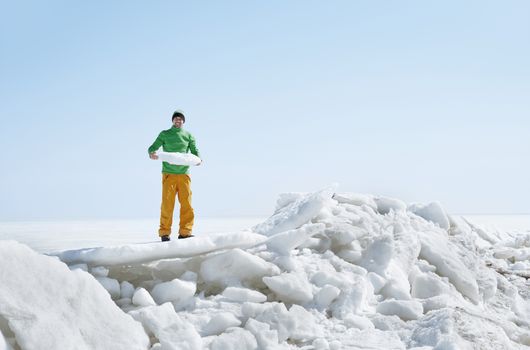 Young adult man outdoors exploring icy landscape