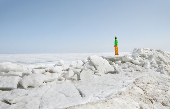 Young adult man outdoors exploring icy landscape