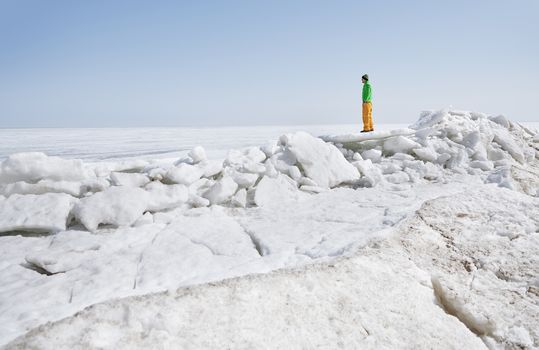 Young adult man outdoors exploring icy landscape