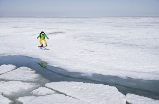 Snowboarding man outdoors in icy and snowy landscape