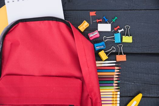 Top view Red bag backpack for education children on black wooden  background back to school concept