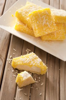 Plate with tasty sweet lemon lamingtons in close up view