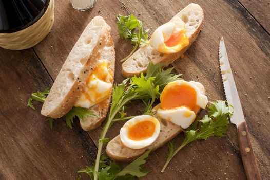 High angle view of fresh bread sices with boiled eggs and salad