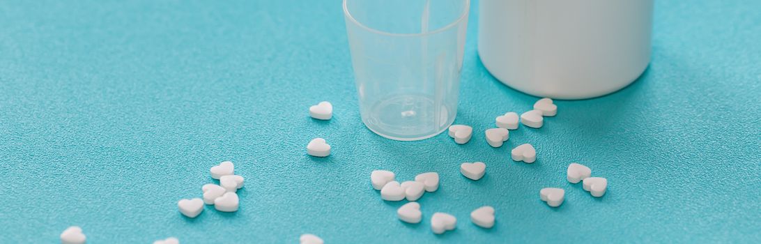 Vitamins and tablets , close-up. Blue background, place to insert text. Modern healthcare and pharmacy.