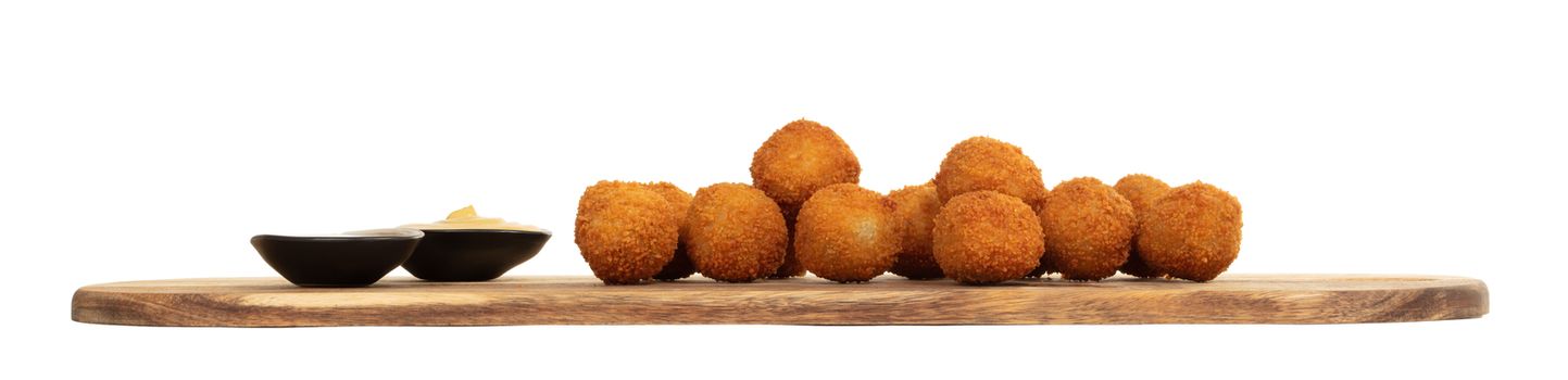 Dutch traditional snack bitterbal on a serving board, isolated