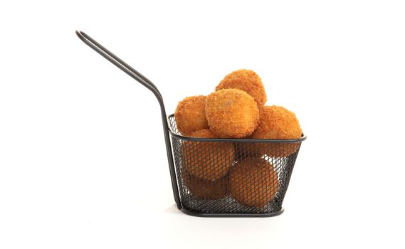 Dutch traditional snack bitterbal in a small basket, isolated