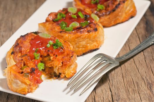 Filling Meat And Cheese Pastries on Plate in Studio