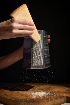 Grated Italian Parmesan Cheese On Wooden Chopping Board
