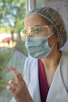 Young doctor exhausted Looking Out Of Window