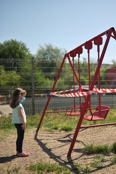 Alone Girl and Children's Swings  Wrapped With Signal Tape