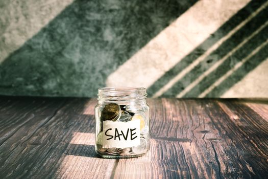 save money, coins in glass jar for money saving financial concept