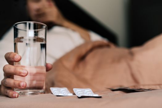 medicine with sick women hand hold a glass of water, healthcare and medicine recovery concept