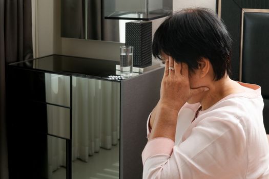 old woman suffering from headache, stress, migraine, health problem concept