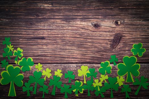St Patricks day, golden coins, festive hat and green Shamrocks on wooden
