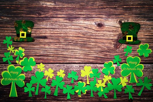 St Patricks day, festive leprechaun hat and green Shamrocks on wooden