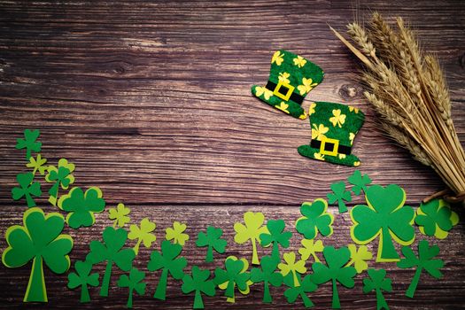 St Patricks day, golden coins, festive hat and green Shamrocks on wooden