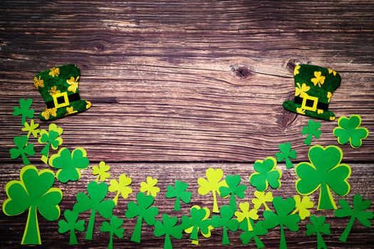 St Patricks day, golden coins, festive hat and green Shamrocks on wooden