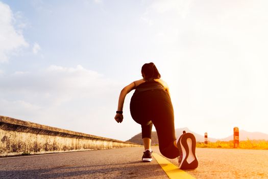 Ready go. running woman on start position and going to run on long road