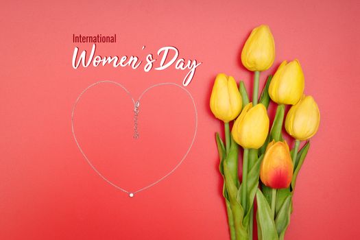 International Womens Day with flowers and heart shape necklace on red background