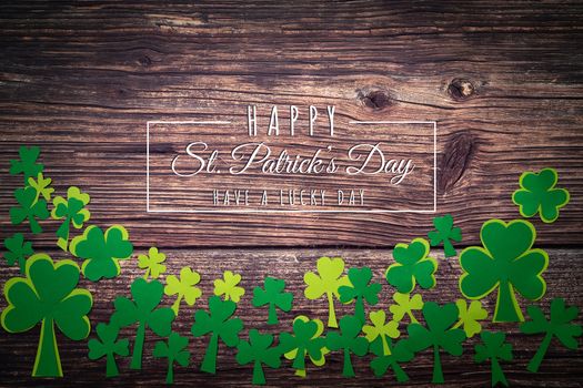 St Patricks Day, golden coins, festive hat and green Shamrocks with saint patricks day lettering on wooden