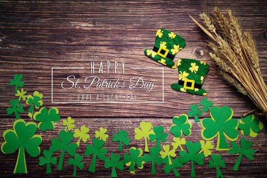St Patricks Day, golden coins, festive hat and green Shamrocks with saint patricks day lettering on wooden