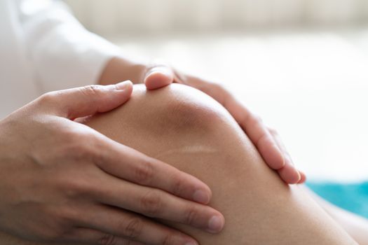 bruised knee of asia woman, selective focus