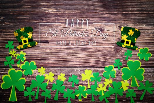 St Patricks Day, golden coins, festive hat and green Shamrocks with saint patricks day lettering on wooden