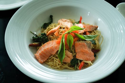 salmon spaghetti, smoked salmon and shrimp egg with spicy Thai herb. Home made food. Concept for a tasty and healthy meal, top view