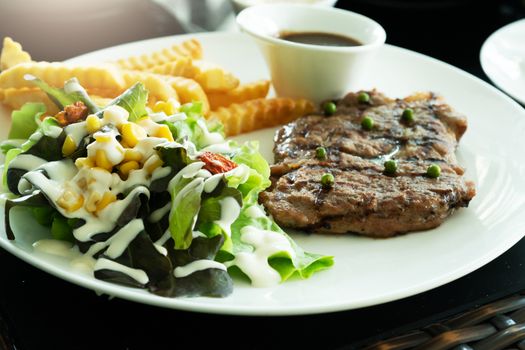 Grilled steak and vegetables salad with potato fried. Home made food. Concept for a tasty and healthy meal
