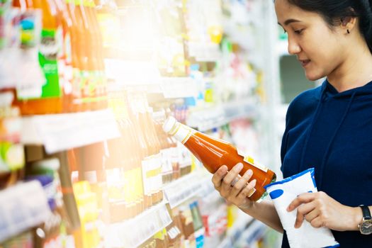 sale, shopping, consumer, woman choosing goods at grocery store or supermarket store