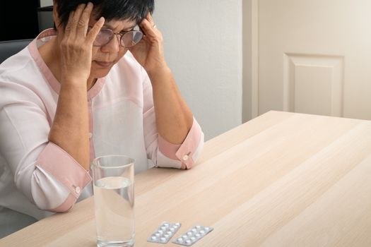 old woman suffering from headache, stress, migraine, health problem concept