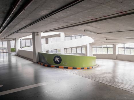 ramp of a parking structure. There is a yellow, black symbol. This image is the parking lot of the department store.