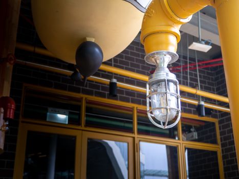 Loft style light bulbs glowing near window. Warm light. Coffee shop interior.