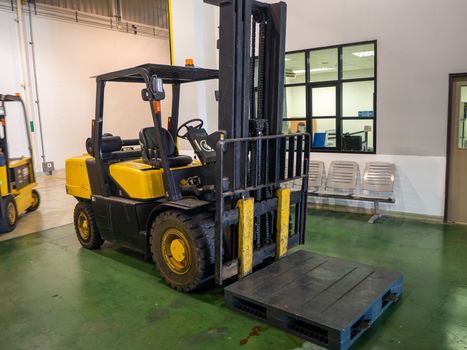 Forklift loader. Pallet stacker truck equipment at warehouse. Background