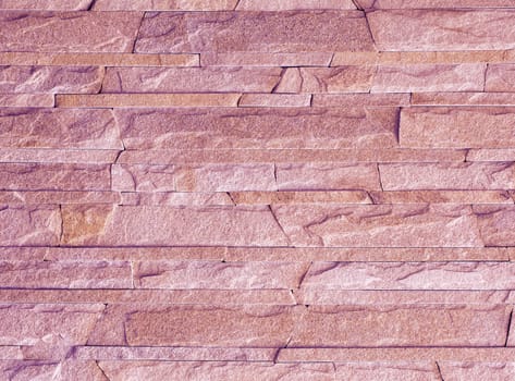 Wall stone mosaic made of pink sandstone texture