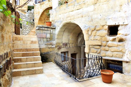 Exterior of a narrow street between the cave houses of Cappadocia, the old city of Goreme in Turkey in the early morning.