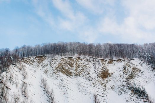 winter landscape with mountain and forest on the slopes