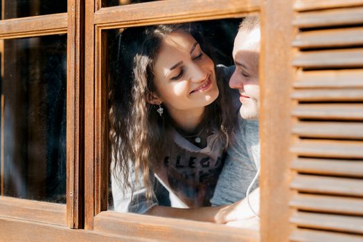 guy and girl in the house near the window overlooking a snowy landscape