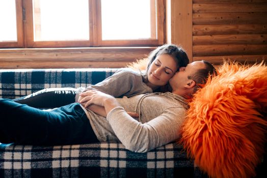 guy and girl in the house near the window overlooking a snowy landscape