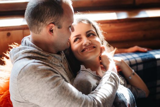 guy and girl in the house near the window overlooking a snowy landscape