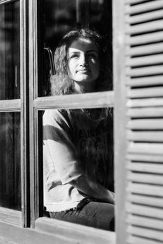 girl in the house near the window overlooking a snowy landscape