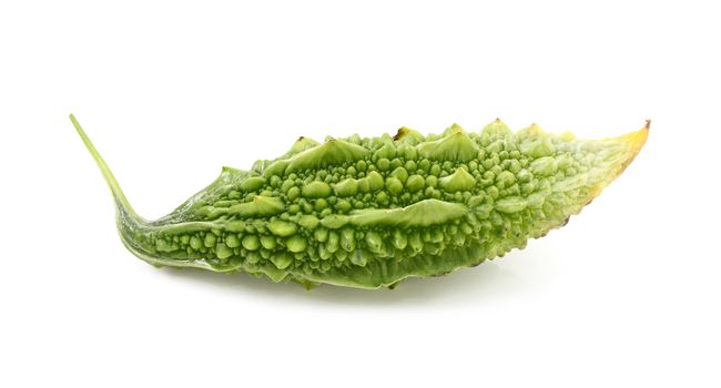 Ripe green bitter melon fruit with unusual ridged skin, isolated on a white background