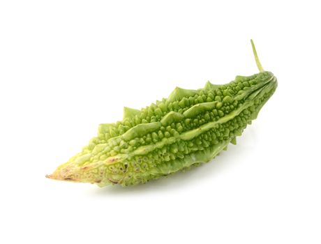 Green bitter melon fruit, harvested when ripe, with warted skin, isolated on a white background