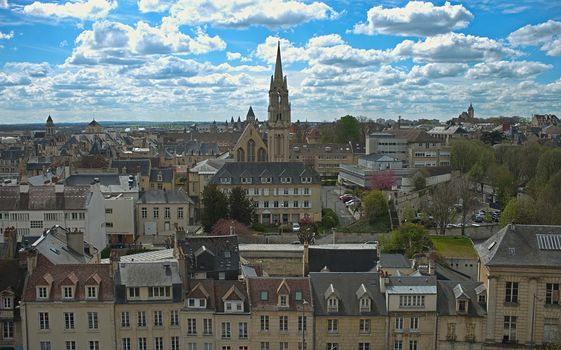 Cityscape of French city Caen with high tower of an catholic cathedral