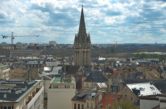 Cityscape of French city Caen with high tower of an catholic cathedral