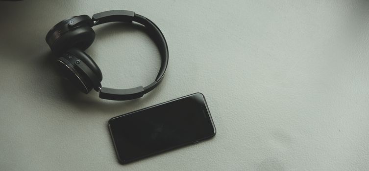 Music headphones and smart phone on rubber floor in fitness gym