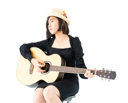 Young asia woman sitting and playing guitar guitar folk song in her hand isolate on white background