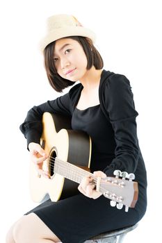 Young asia woman sitting and playing guitar guitar folk song in her hand isolate on white background